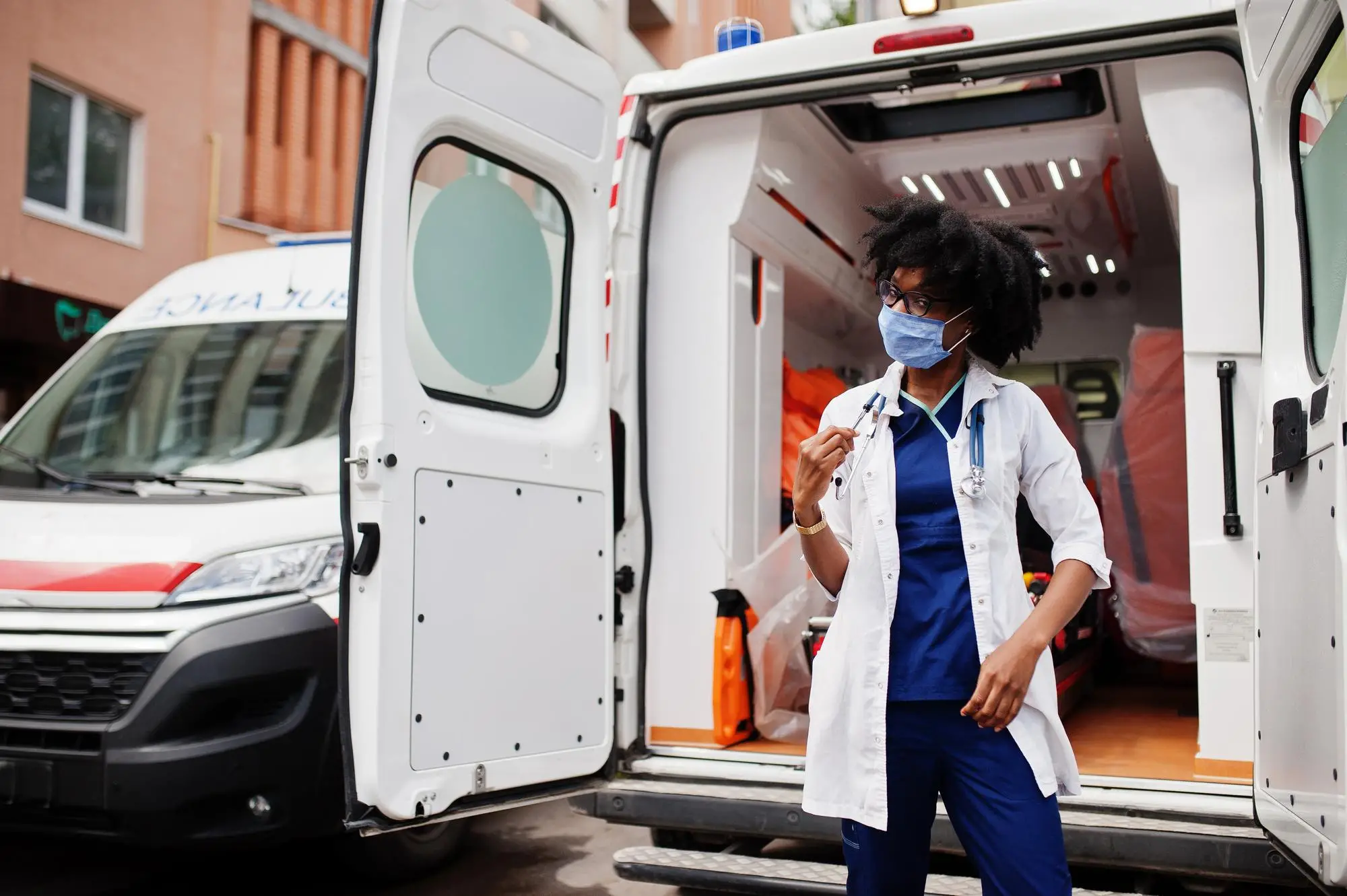 personnel devant l'arrière d'une ambulance